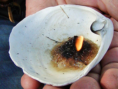 A fat lamp with natural fiber wick.